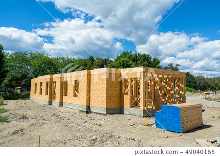 Wooden frame of new building with lumber materials prepared for construction 49040168