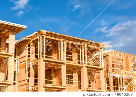 Apartment building under construction on sunny day on blue sky background Apartment building under construction on sunny day on blue sky background 49040206