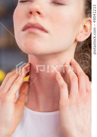 Disturb young woman closing her eyes and scratching neck Disturb young woman closing her eyes and scratching neck 49041213