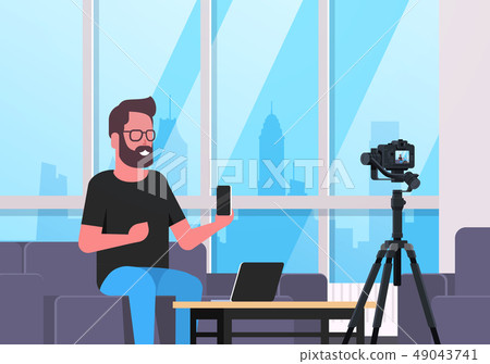 guy technology blogger recording video on camera man showing new smartphone functional testing blog 49043741
