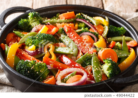 Stir fry of vegetables with sesame close-up Stir fry of vegetables with sesame close-up 49044422