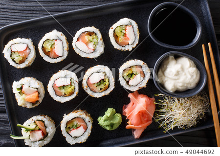 set of Japanese rolls uramaki served with sauces, 49044692