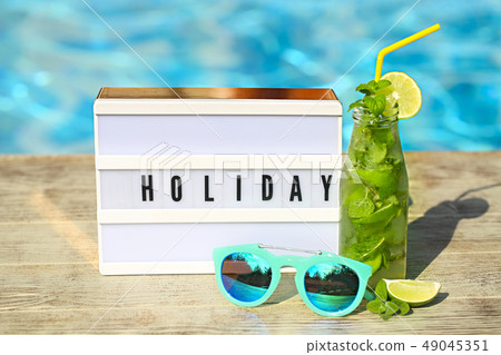 Light letterbox with word Holiday, hat, sunglasses Light letterbox with word Holiday, hat, sunglasses 49045351
