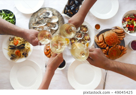 People fine dining seafood and white wine on the People fine dining seafood and white wine on the 49045425