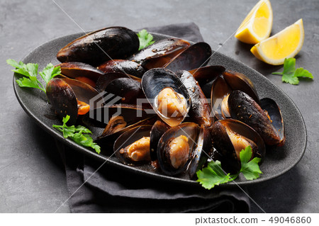 Delicious mussels with tomato sauce and parsley 49046860
