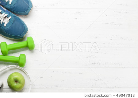 Fitness concept. Dumbbells, sneakers, headphones 49047018