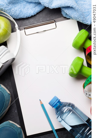 Fitness concept. Dumbbells, sneakers, headphones 49047031