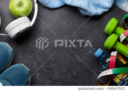Fitness concept. Dumbbells, sneakers, headphones 49047032