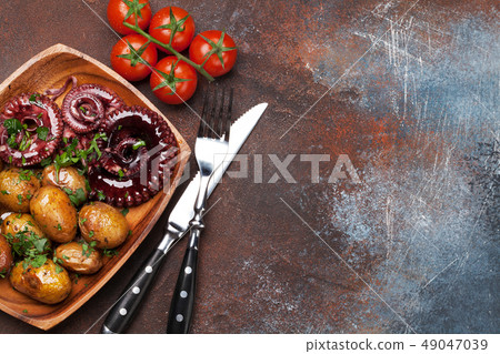 Grilled octopus with small potatoes 49047039