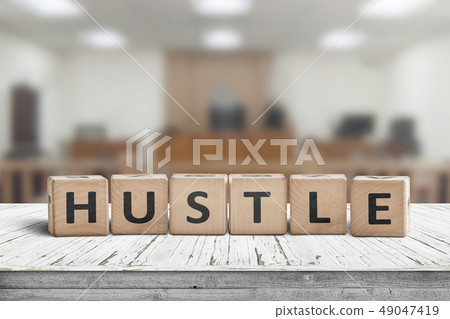 Hustle sign with text on a worn desk Hustle sign with text on a worn desk 49047419