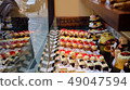 Woman looking at the delicious cake in the show window 49047594