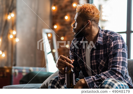 Nice thoughtful man turning his head to the window Nice thoughtful man turning his head to the window 49048179