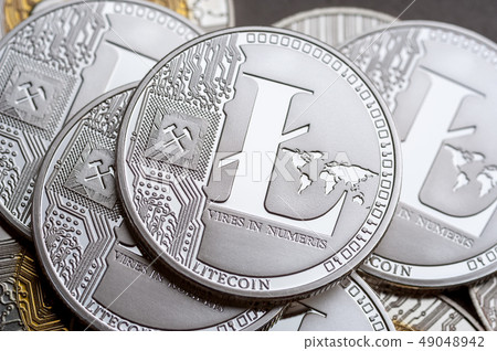 Group of silver litecoin coins, close-up. 49048942