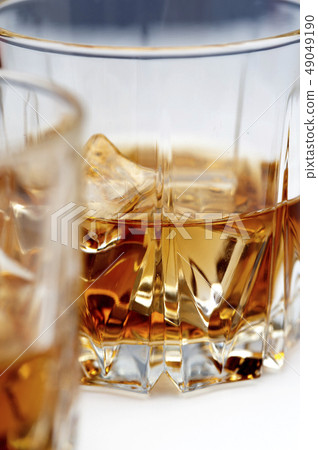 Glasses of scottish whiskey with ice cubes Glasses of scottish whiskey with ice cubes 49049190