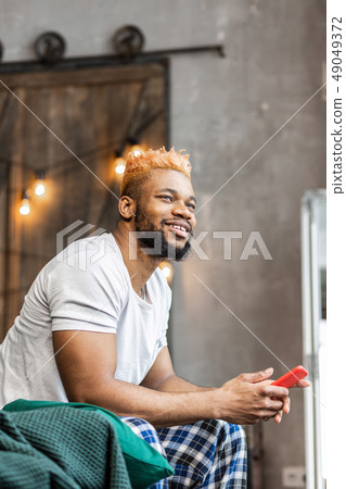 Nice good looking man sitting with his phone 49049372