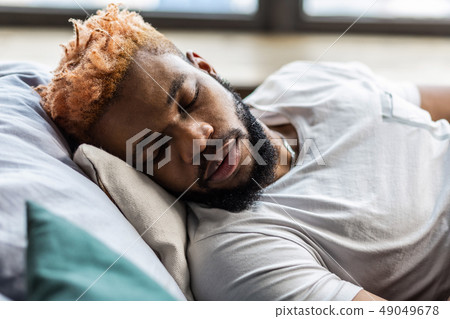 Nice bearded young man enjoying his sleep 49049678