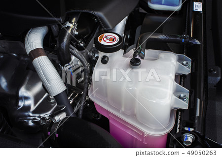 Coolant tank with a pink liquid antifreeze. Coolant tank with a pink liquid antifreeze. 49050263