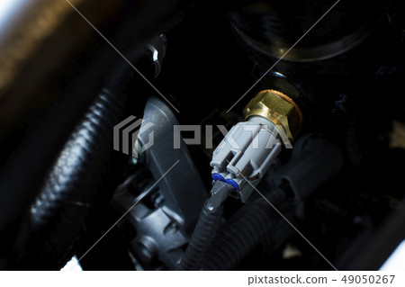 Engine sensor an installed on a car engine. 49050267