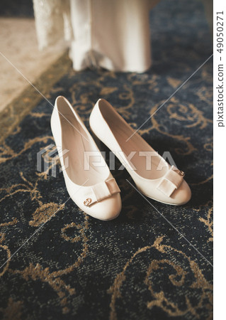 White stylish wedding shoes for bride. Close-up White stylish wedding shoes for bride. Close-up 49050271
