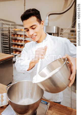 Baker wearing white uniform preparing everything for cooking 49051076
