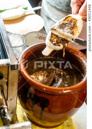 Apply miso sauce to Gohei mochi Apply miso sauce to Gohei mochi 49051406