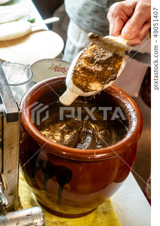 Apply miso sauce to Gohei mochi Apply miso sauce to Gohei mochi 49051407