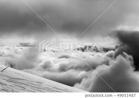 Snowy ski slope for slalom and overcast sky before 49051487
