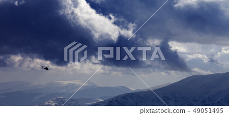 Helicopter in winter mountains and cloudy sky Helicopter in winter mountains and cloudy sky 49051495