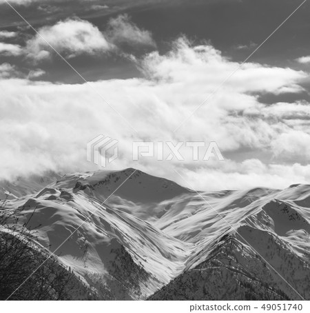 Snowy winter mountains and sky with sunlight Snowy winter mountains and sky with sunlight 49051740