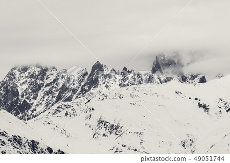 Rocky mountains in snow and overcast gray sky Rocky mountains in snow and overcast gray sky 49051744