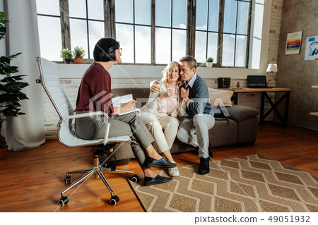 Desperate good-looking couple sitting closely to each other 49051932