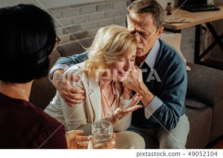 Good-looking expressive woman with blond hair crying and yelling Good-looking expressive woman with blond hair crying and yelling 49052104