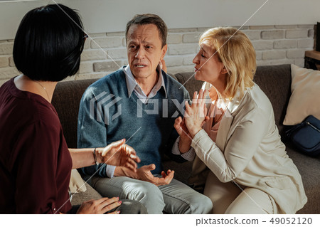 Upset short-haired man in blue sweater explaining his issues 49052120