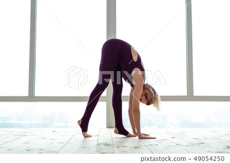 Hard-working young blonde lady in violet outfit bending over Hard-working young blonde lady in violet outfit bending over 49054250