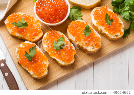 Sandwiches with red salmon caviar on a wooden Sandwiches with red salmon caviar on a wooden 49054692