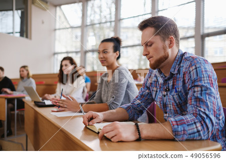Multinational group of students in an auditorium 49056596