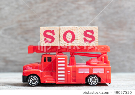 Red fire truck hold letter block in word SOS 49057530
