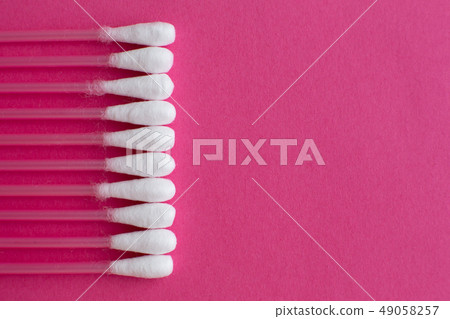 Closeup top view on cotton buds laid in a vertical 49058257