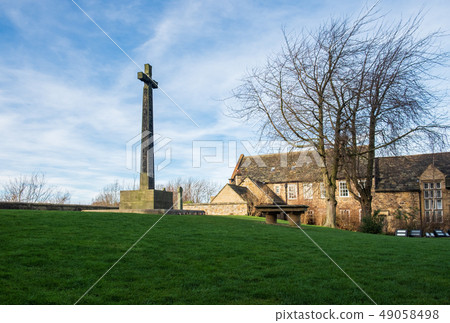 Grave stone and cross in the yard of Durham 49058498