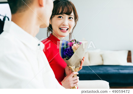 Couple present flower anniversary 49059472