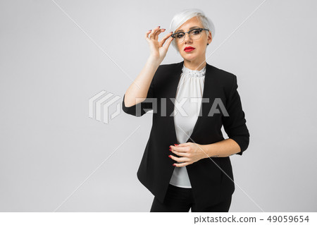 Portrait of young buisness lady in costumes isolated on background Portrait of young buisness lady in costumes isolated on background 49059654