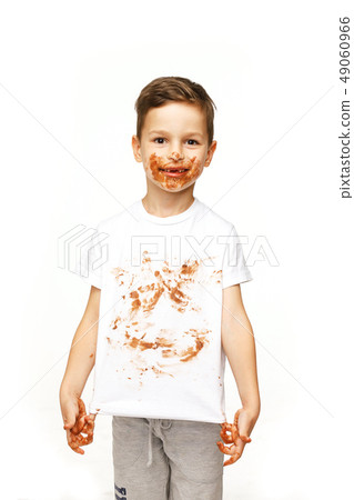 little boy with face and hands in chocolate little boy with face and hands in chocolate 49060966
