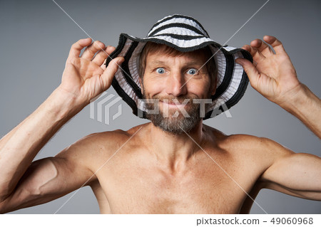 Funny portrait of mature man topless wearing summer hat Funny portrait of mature man topless wearing summer hat 49060968
