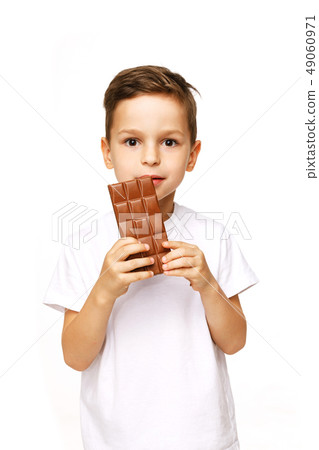 little beautiful boy holding chocolate studio shot  49060971