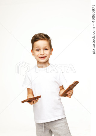 little beautiful boy holding chocolates studio shot little beautiful boy holding chocolates studio shot 49060973