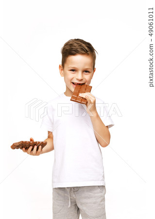 little beautiful boy holding chocolates studio shot  49061011