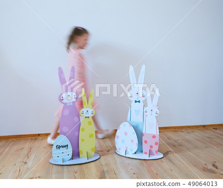 Cardboard Easter bunnies. Easter decor for party. Film effect 49064013