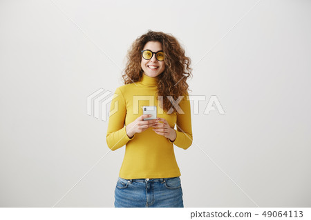 Image of gorgeous woman in casual being surprised or excited to receive pleasant text message on her 49064113