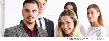 Group of smiling people stand in office Group of smiling people stand in office 49065402