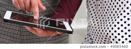 Businessman points a finger at the tablet 49065460